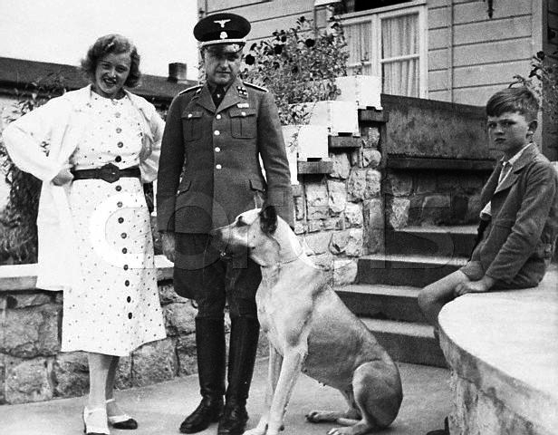 The commandant of the Buchenwald Concentration Camp, SS Colonel Karl Koch stands with his wife Ilsa their son and dog. ca. 1930s-1940s Germany